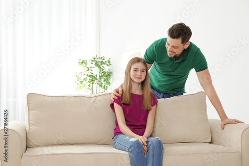 Father talking with his teenager daughter at home