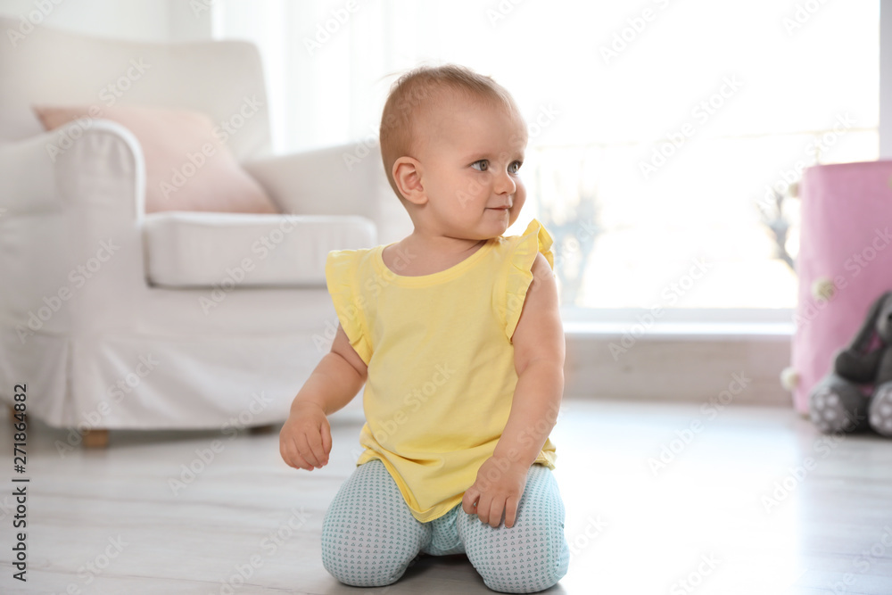 Fototapeta premium Cute baby girl on floor in room