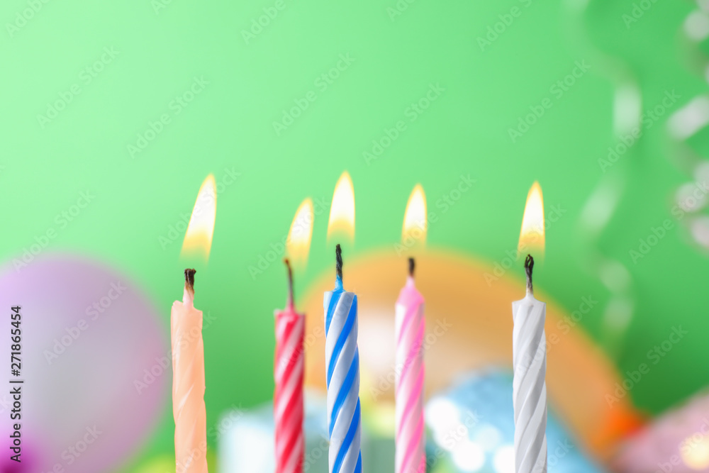Burning birthday cake candles on color background. Space for text Burning birthday cake candles on color background. Space for text