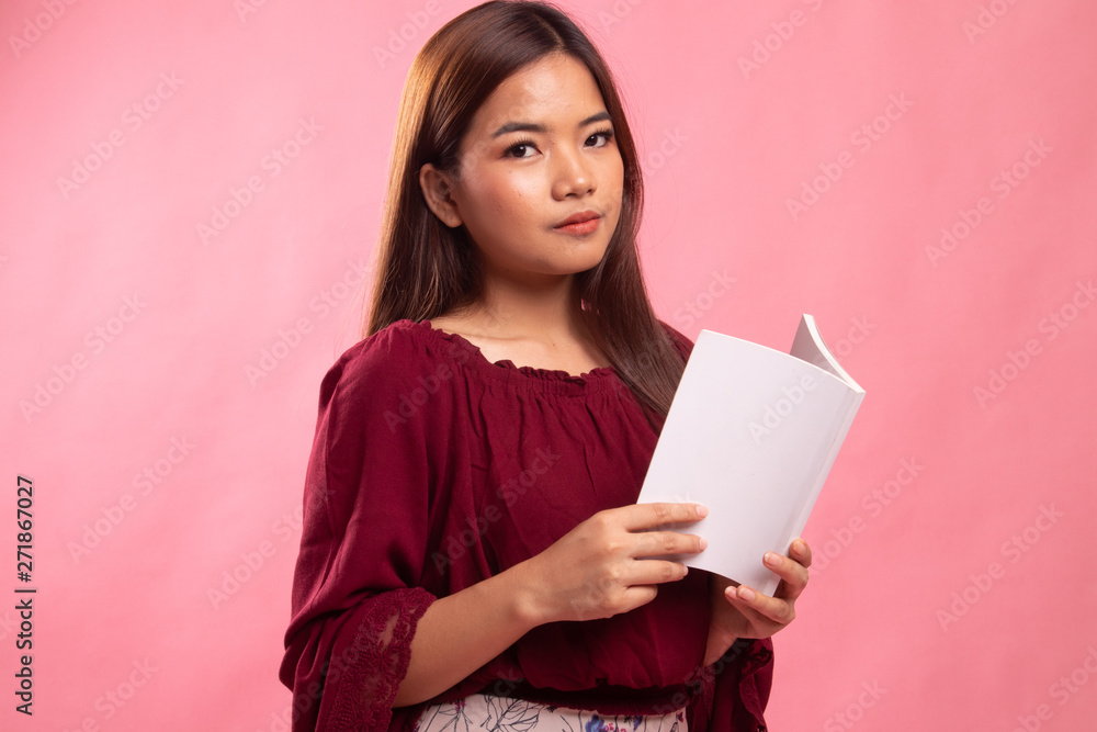 Young Asian woman with a book. Young Asian woman with a book.