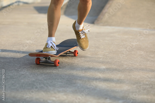 skater legs skating at skatepark photo