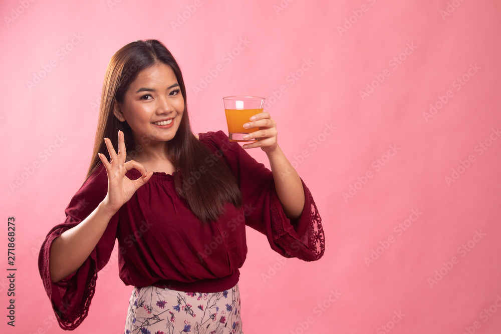 Young Asian woman show OK drink orange juice. Young Asian woman show OK drink orange juice.