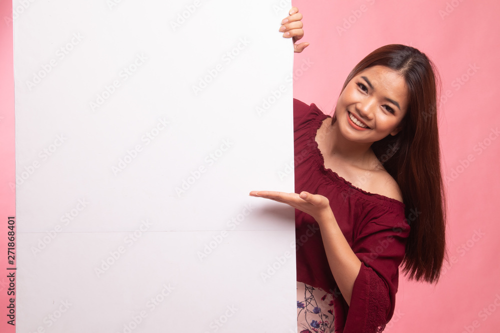 Young Asian woman present blank sign with palm hand. Young Asian woman present blank sign with palm hand.