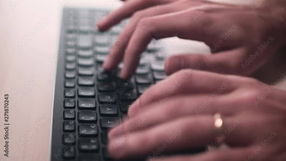 Computer keyboard. The man is writing on the keyboard. The camera is in motion - on dolly. Close-up, counter-light, low depth - film depth of field. Computer keyboard. The man is writing on the keyboard. The camera is in motion - on dolly. Close-up, counter-light, low depth - film depth of field.