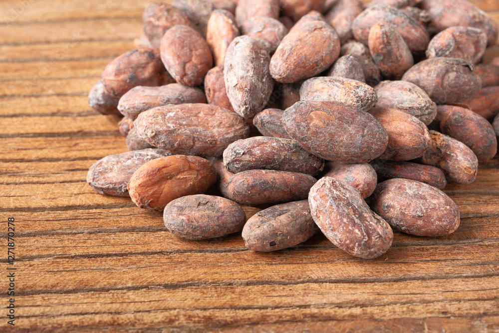 dried cacao beans on the wooden board dried cacao beans on the wooden board