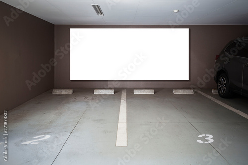 Parking garage underground interior with blank billboard