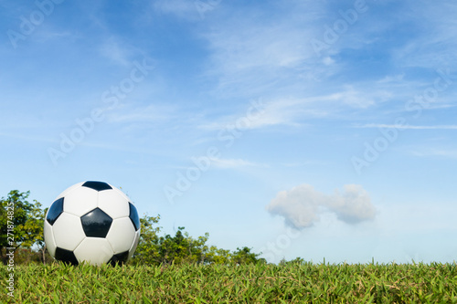football on grass with cloud and sky background