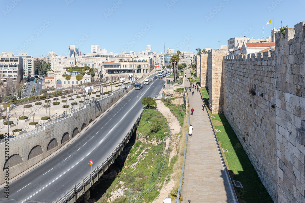 Fototapeta premium View from the city wall to Khativat Yerushalayim street passing near Jaffa Gate and the fortress walls city walls in old city of Jerusalem, Israel