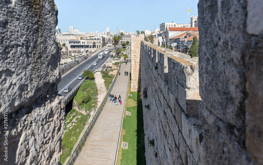 View from the city wall to Khativat Yerushalayim street passing near Jaffa Gate and the fortress walls city walls in old city of Jerusalem, Israel