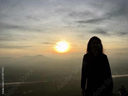Silhouette portrait of woman on sunset background