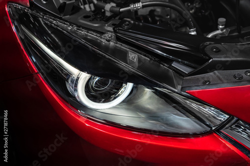 Red car, headlight and engine. © oats