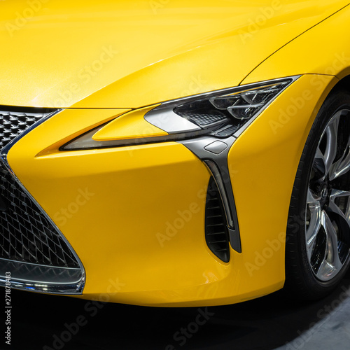 Headlights of yellow car. © oats