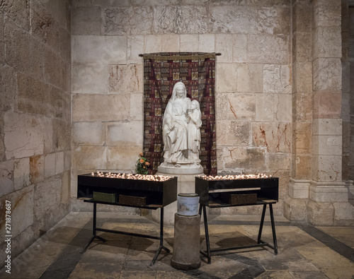 Tables with candles stand in front of the statue in the Church of Saint Anne near Pools of Bethesda in the old city of Jerusalem, Israel photo