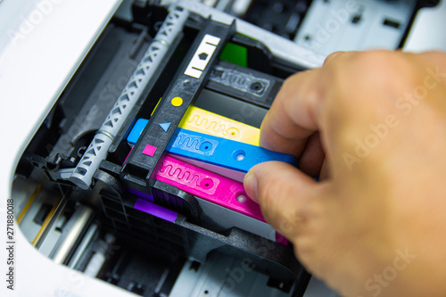 Technicians are installing the color printer inkjet cartridge