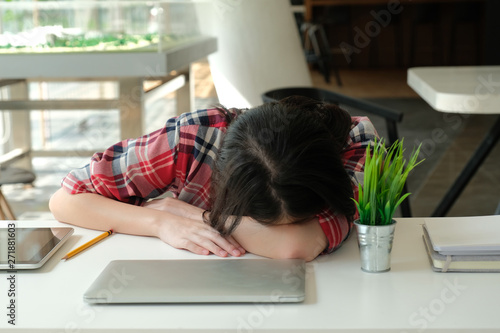 woman sleeping at workplace. girl tired from hard work