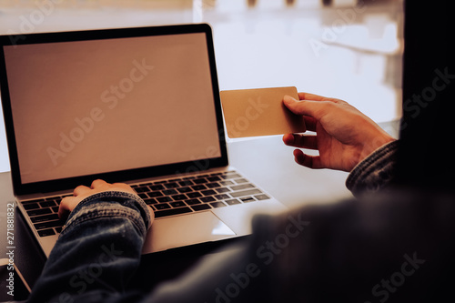 woman holding credit card using computer for shopping online