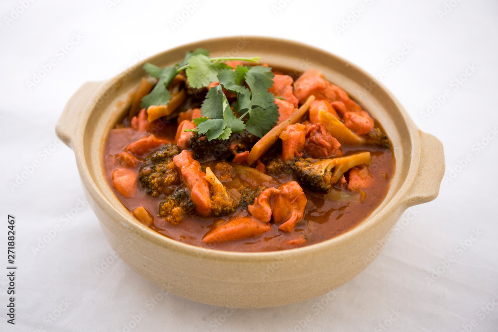 Butter chicken curry with Broccoli in Bowl Butter chicken curry with Broccoli in Bowl
