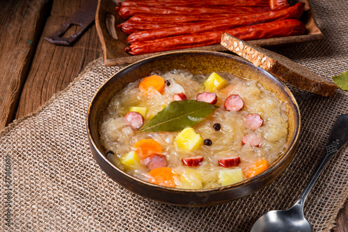 rustic sauerkraut soup with bacon and sausage photo