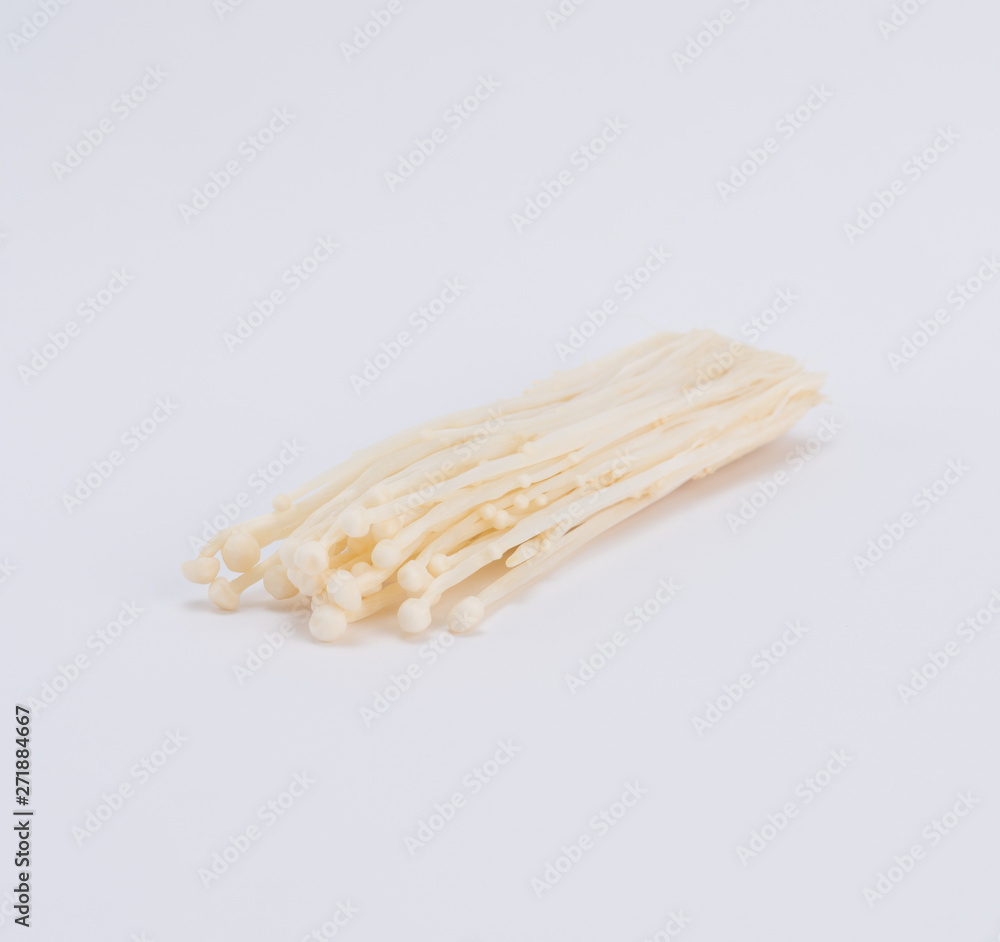 Enokitake or enoki (Flammulina velutipes) white mushroom and also known by the name golden needle mushroom or lily mushroom Enokitake or enoki (Flammulina velutipes) white mushroom and also known by the name golden needle mushroom or lily mushroom