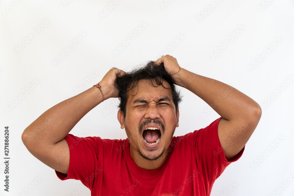 Enraged furious asian man open his mouth and screaming in anger and stress, pulling his hair out with his hand, stand isolated on white background and make grimace closed eyes. Space for text Enraged furious asian man open his mouth and screaming in anger and stress, pulling his hair out with his hand, stand isolated on white background and make grimace closed eyes. Space for text