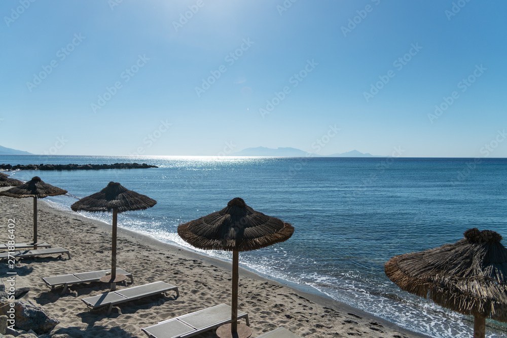 Umbrellas on Kardamena city beach in Kos island, Greece.