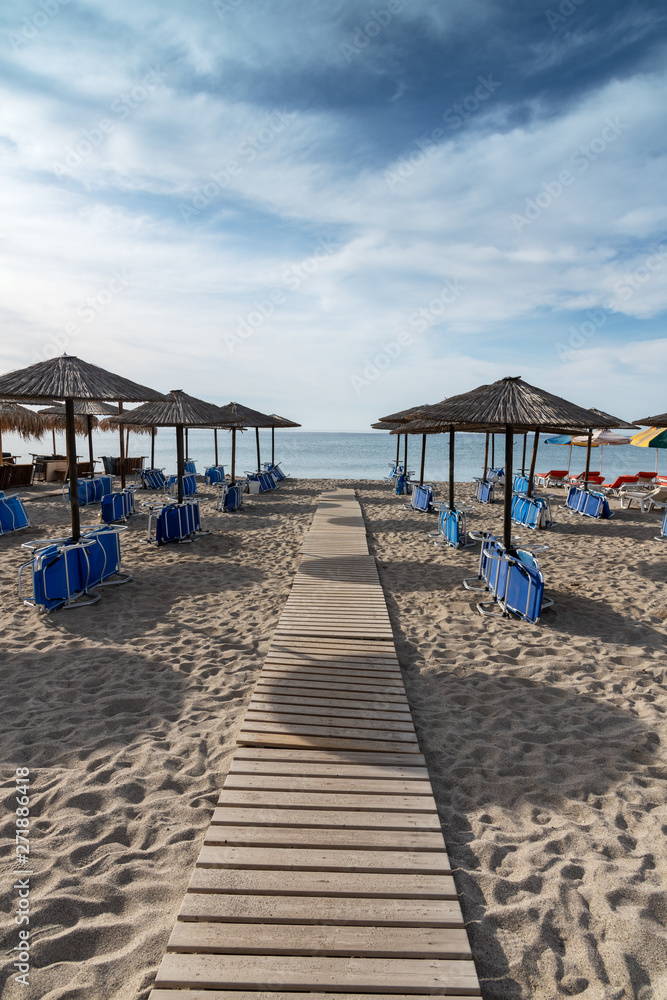 Umbrellas on Kardamena city beach in Kos island, Greece.