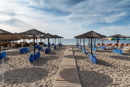 Fototapeta Naklejka Na Ścianę i Meble -  Umbrellas on Kardamena city beach in Kos island, Greece.