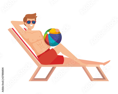 young man relaxing in beach chair with balloon toy