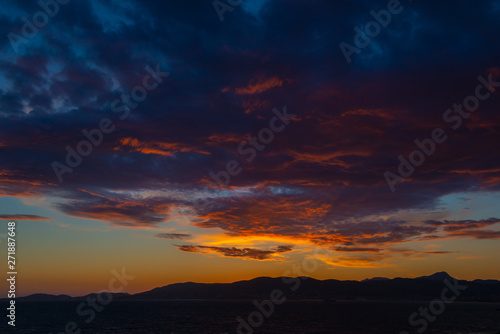 Panoramic view of Mediterranean sea, sky with dramatic clouds at golden sunset in Palma de Mallorca, Spain. © Khorzhevska