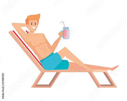 young man relaxing in beach chair drinking juice fruit