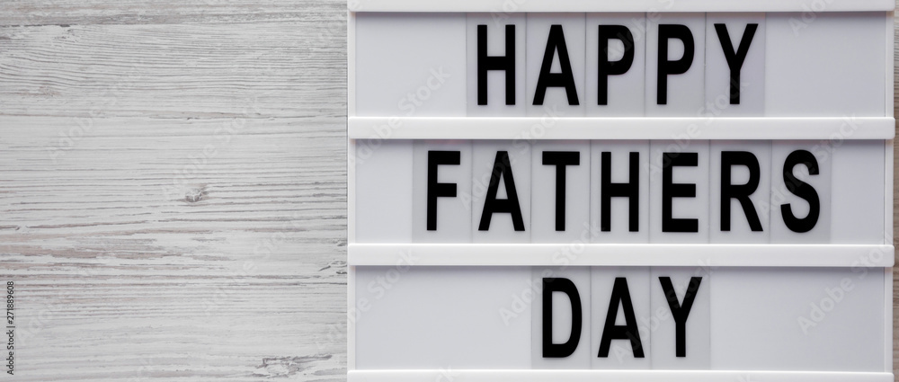 Light box with 'Happy Fathers Day' words on a white wooden background, top view. Overhead, from above, flat lay. Copy space. Light box with 'Happy Fathers Day' words on a white wooden background, top view. Overhead, from above, flat lay. Copy space.