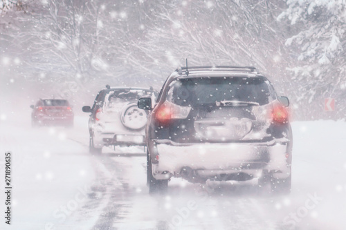 Winter, snow, Blizzard, poor visibility on the road. Car during a Blizzard on the road with the headlights. © Shcherbyna