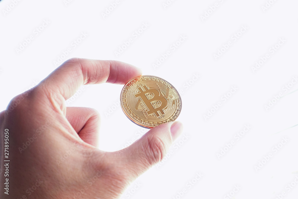 Hand hold a Gold bitcoin Hand hold a Gold bitcoin
