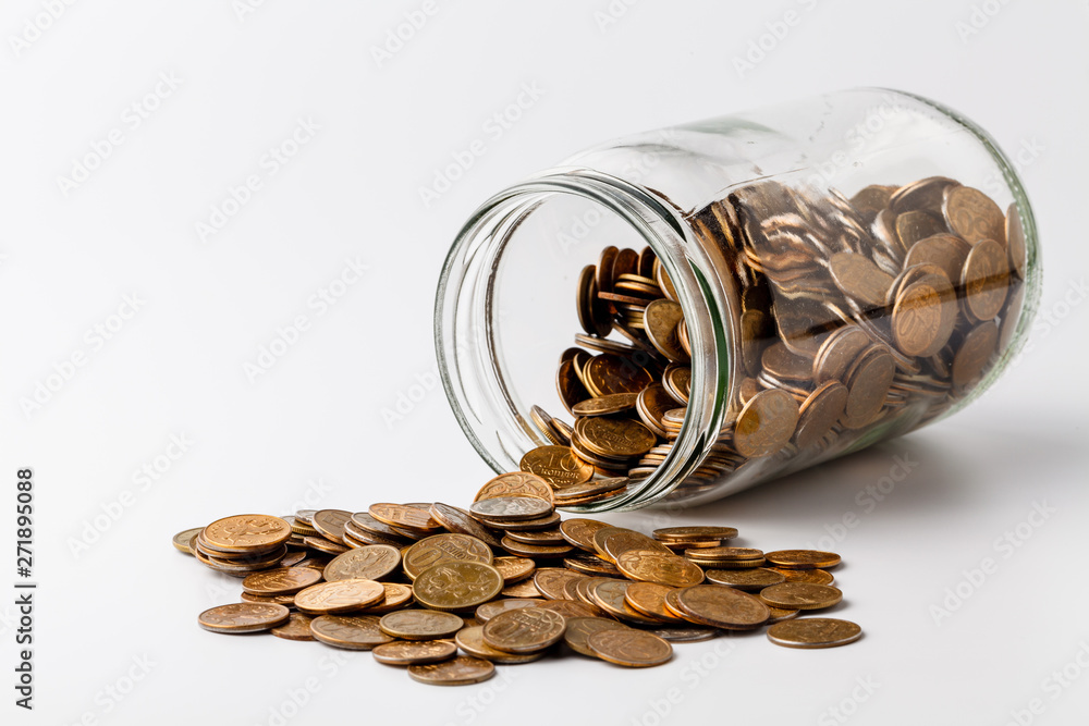 Gold coins spilling out of a jar on white background Gold coins spilling out of a jar on white background