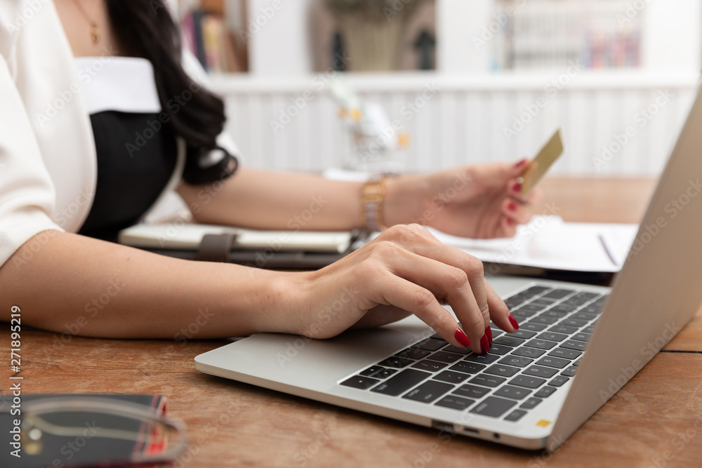 Freelancer business woman using computer laptop and credit cart to shopping online in cafe. Freelancer business woman using computer laptop and credit cart to shopping online in cafe.