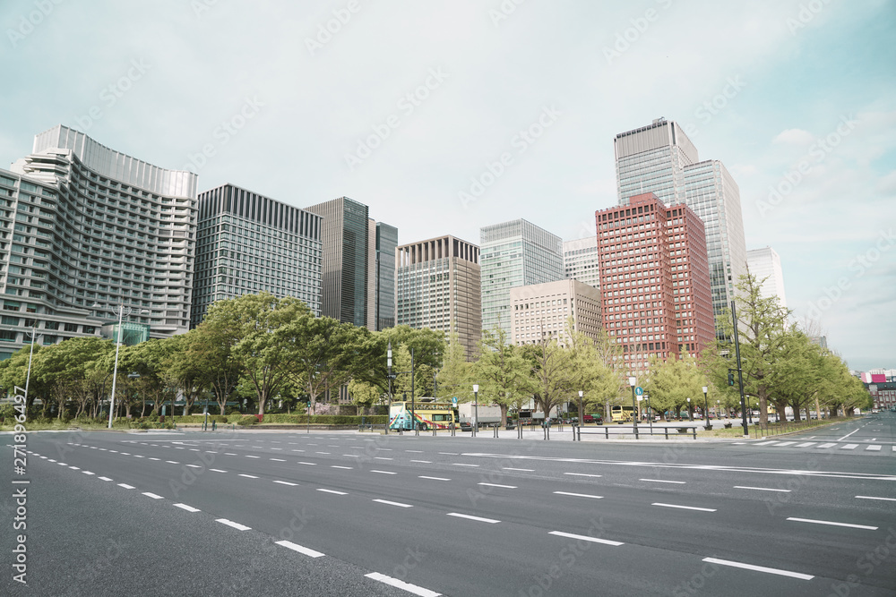 A group building with tree and road in a modern city in Tokyo. - Image A group building with tree and road in a modern city in Tokyo. - Image