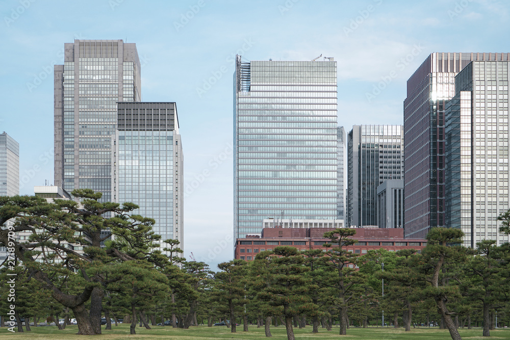 A group building with tree and road in a modern city in Tokyo. - Image