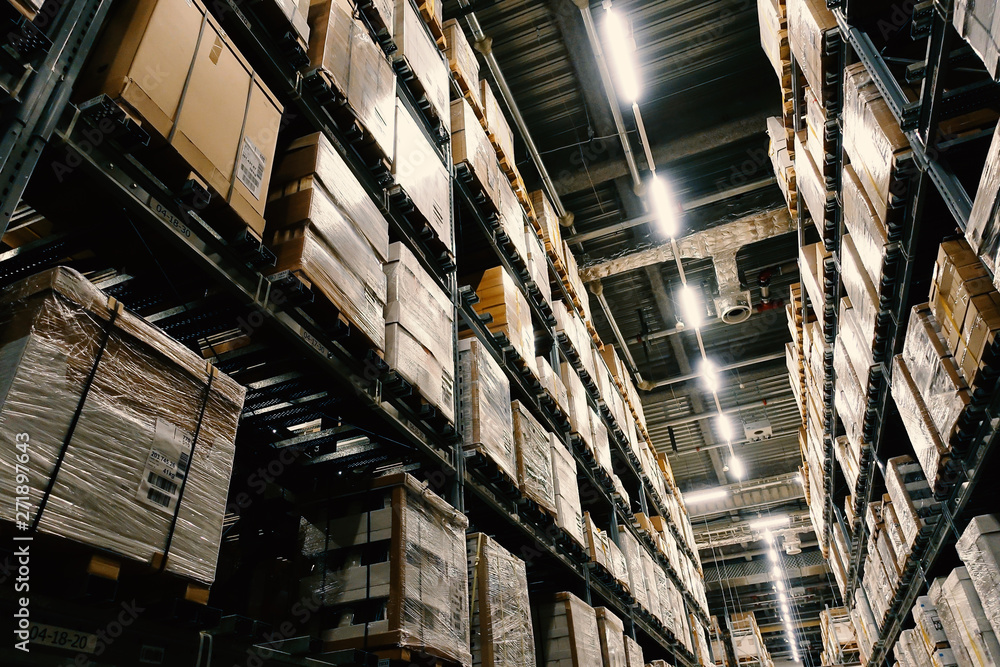 Large wharehouse with rows of shelves and goods boxes. Large wharehouse with rows of shelves and goods boxes.