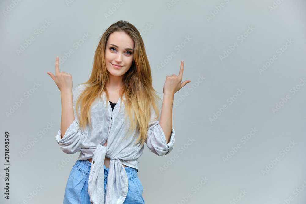 Photograph of a portrait of a beautiful girl woman with long dark flowing hair, satisfied life on a gray background. She stands in front of the camera in different poses with different emotions. Photograph of a portrait of a beautiful girl woman with long dark flowing hair, satisfied life on a gray background. She stands in front of the camera in different poses with different emotions.