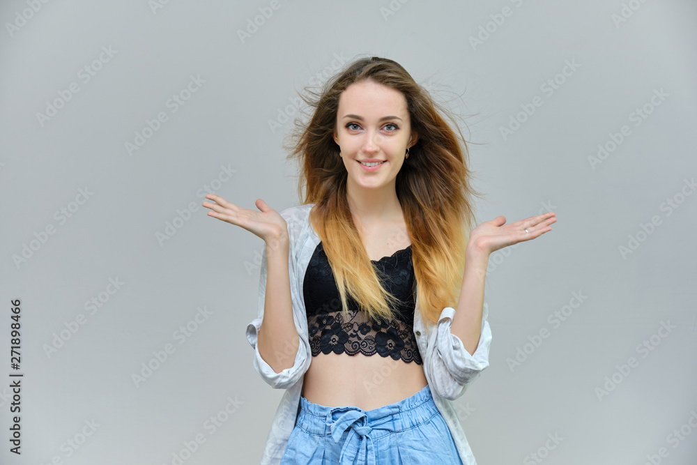 Photograph of a portrait of a beautiful girl woman with long dark flowing hair, satisfied life on a gray background. She stands in front of the camera in different poses with different emotions. Photograph of a portrait of a beautiful girl woman with long dark flowing hair, satisfied life on a gray background. She stands in front of the camera in different poses with different emotions.