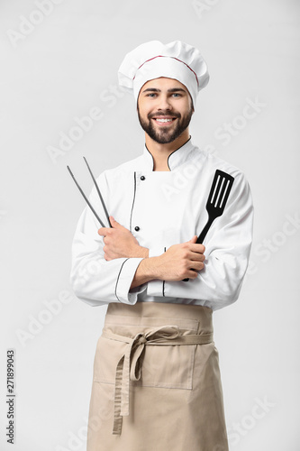 Handsome male chef on white...