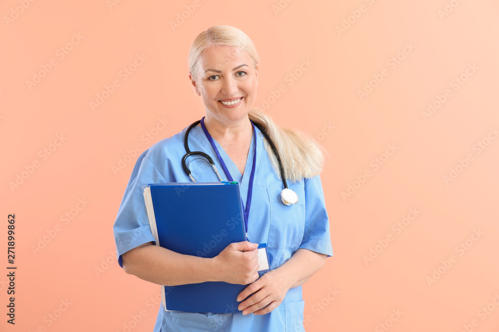 Mature medical assistant on color background Mature medical assistant on color background
