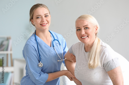 Smiling female nurse assist...