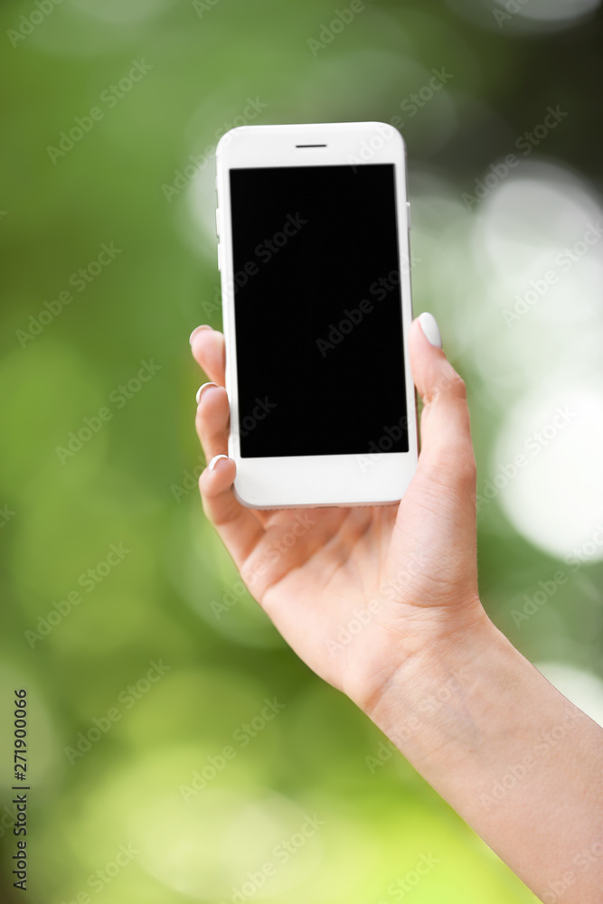 Young woman with mobile phone outdoors