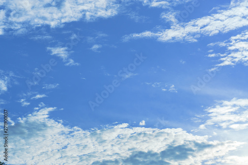 Beautiful view of white fluffy clouds on a clear blue sky background. Nature weather on the vast cloud blue sky. Sky daylight in summer. Natural background with copy space. Element of design. © Joe