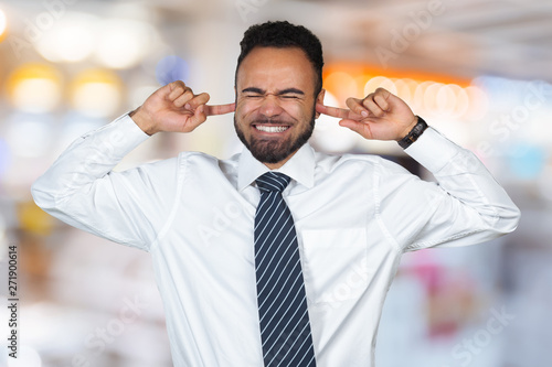 I don`t want to hear it! Dark-skinned male closing ears with fingers