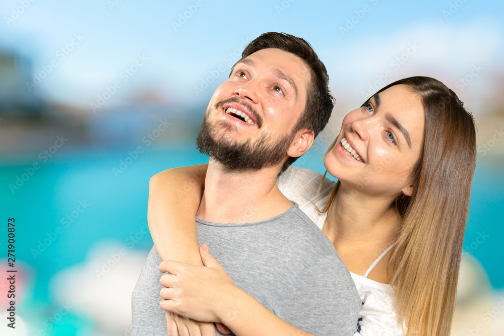 Happy couple embracing and looking at camera