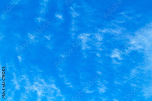 Blue sky with picturesque fluffy clouds background