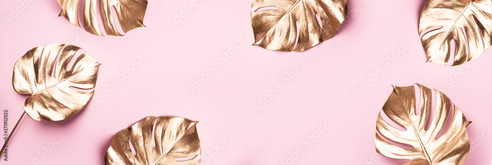 Exotic summer trend in minimal style. Golden tropical palm monstera leaf on pastel pink color background. Shiny and sparkle design, fashion concept. Exotic summer trend in minimal style. Golden tropical palm monstera leaf on pastel pink color background. Shiny and sparkle design, fashion concept.