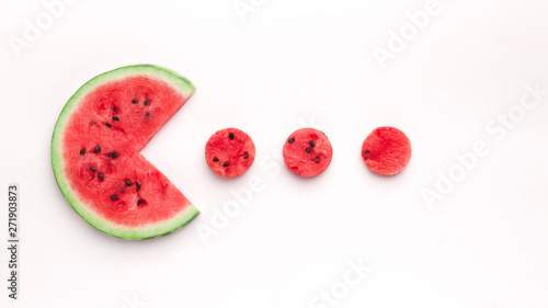 Watermelon Pacman eating small red round pieces